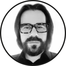 A stylized black and white profile image of a man with glasses and a beard.