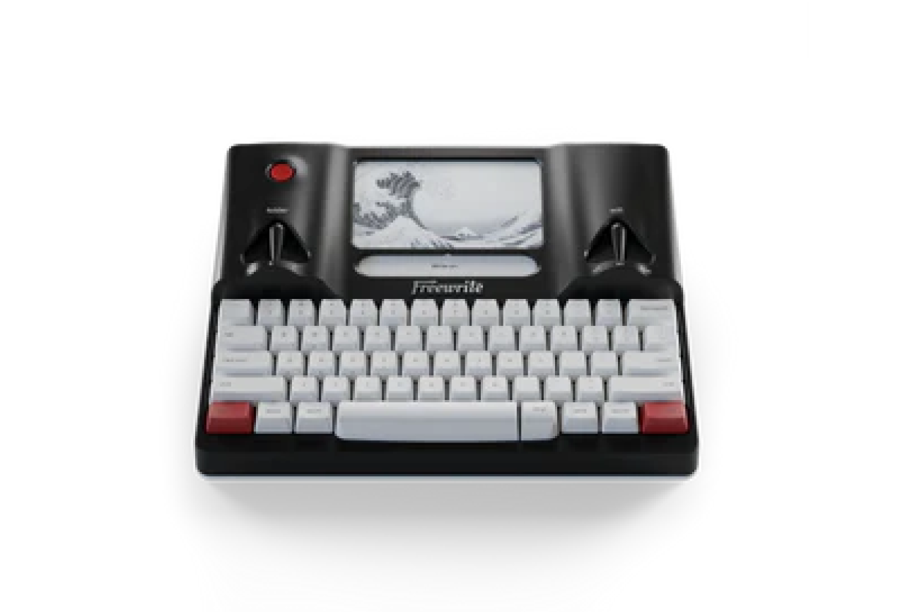 A Freewrite smart typewriter with a small digital screen and mechanical keyboard.