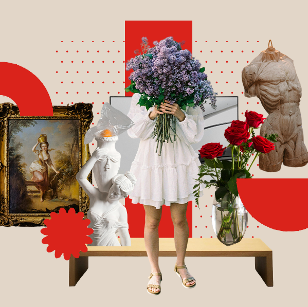 Person holding a large bouquet of flowers surrounded by various art and floral arrangements.